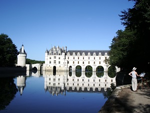 chateau of Chenonceau in summer with painter and Cher river, tributary of the Loire